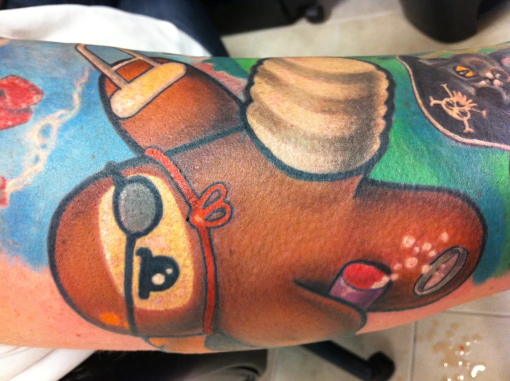 this tattoo depicts the character slotty from the movie, with his arm and shoulder covered in a slotty character