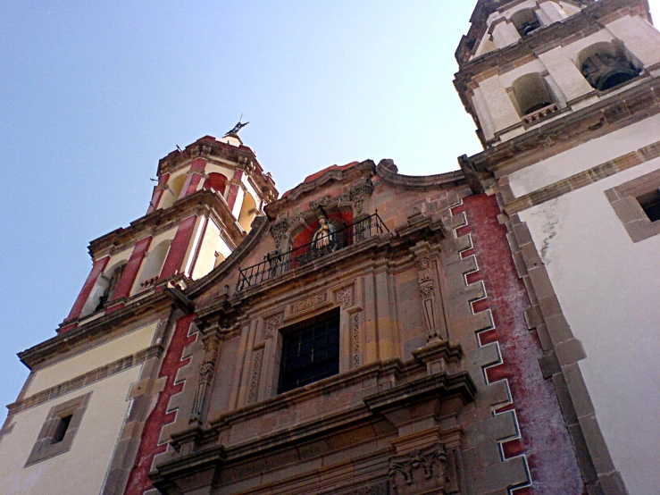 two towers of a building with clock displayed on the front