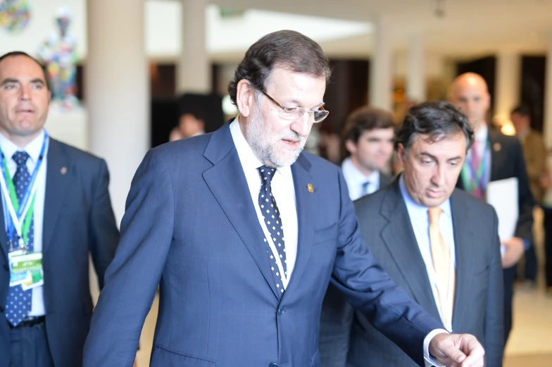 the three men are dressed nicely in suits and ties