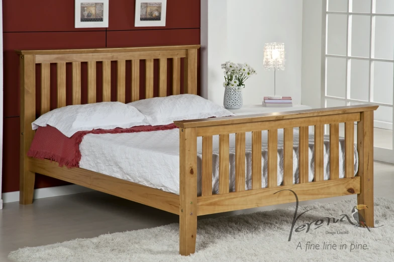 a wooden bed frame with an unmade up mattress