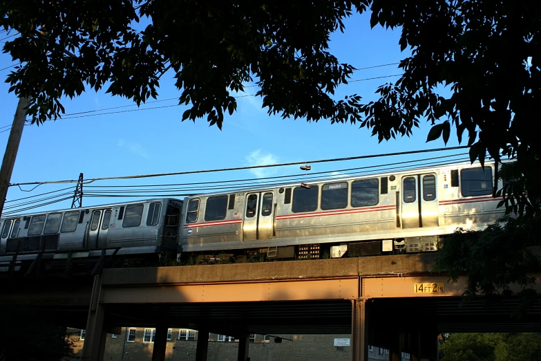 commuter train on elevated track moving through urban city