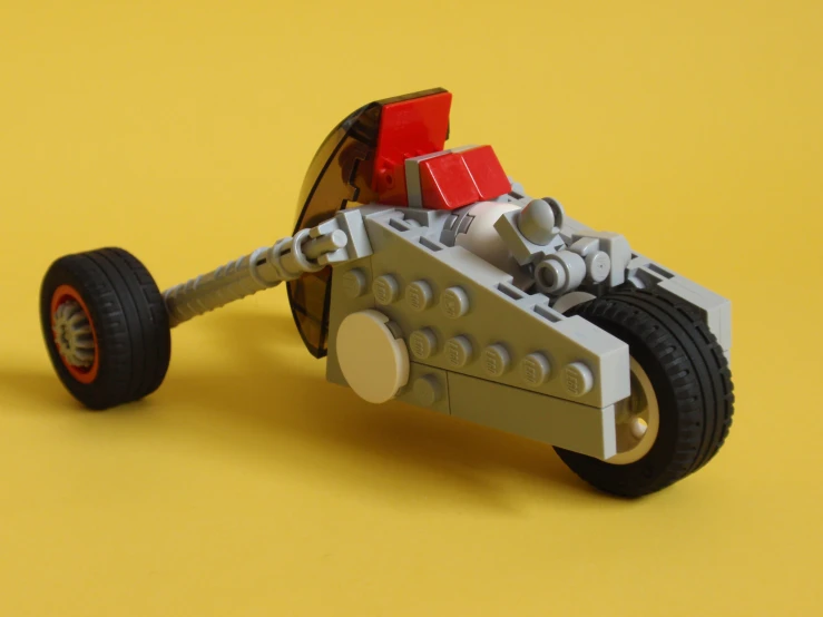 lego vehicle made from lego parts on yellow background