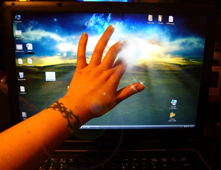a close up of a hand on top of a laptop