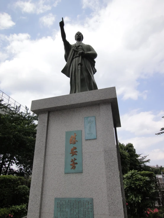 a statue of a woman holding up a sign