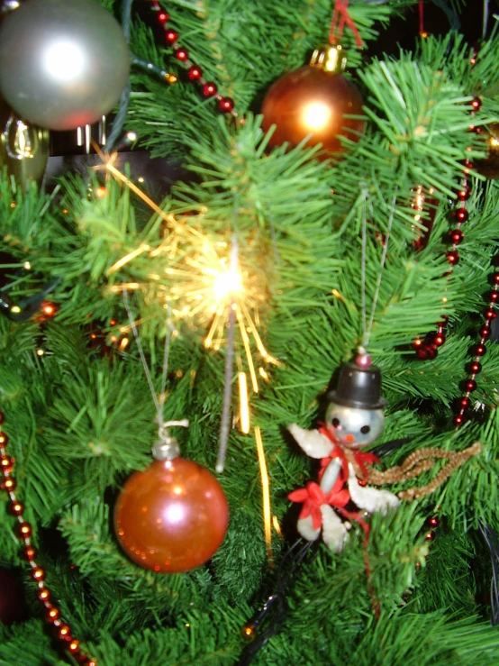 a pine tree with ornaments and decorations on it