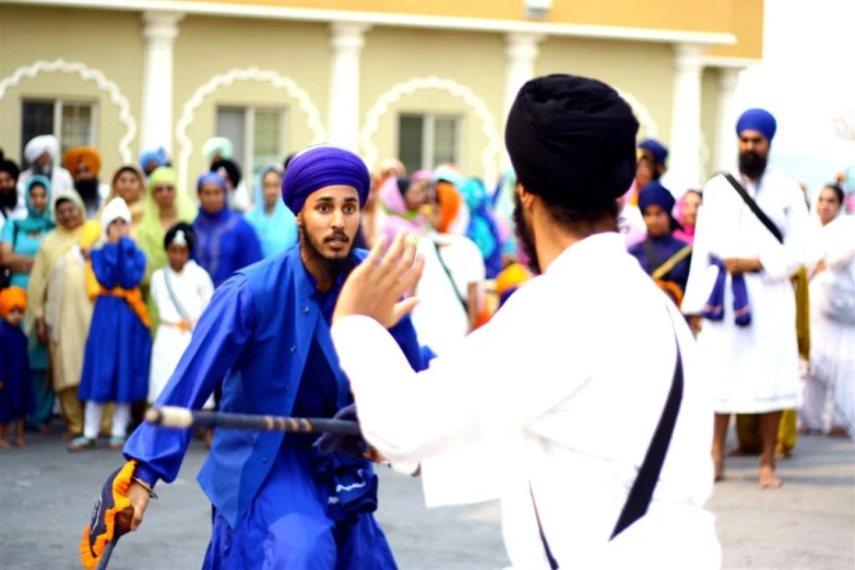 two men dancing in front of a large group