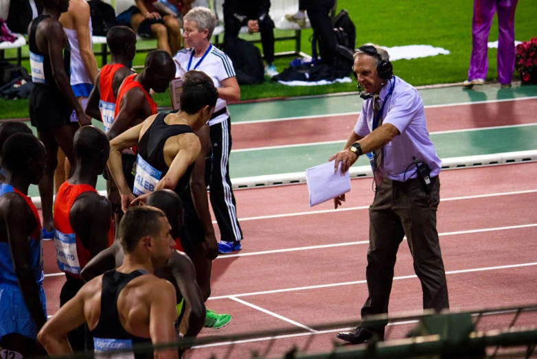 a man in grey jacket standing on a track