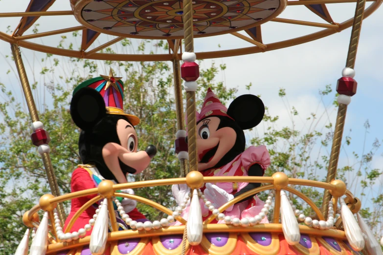 mickey and minnie mouse in a carousel at disney world