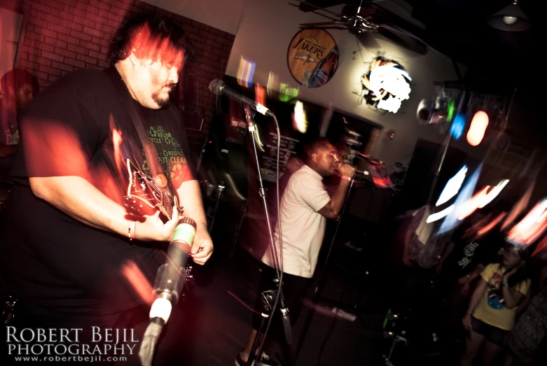 people at a karaoke playing music on a brick wall