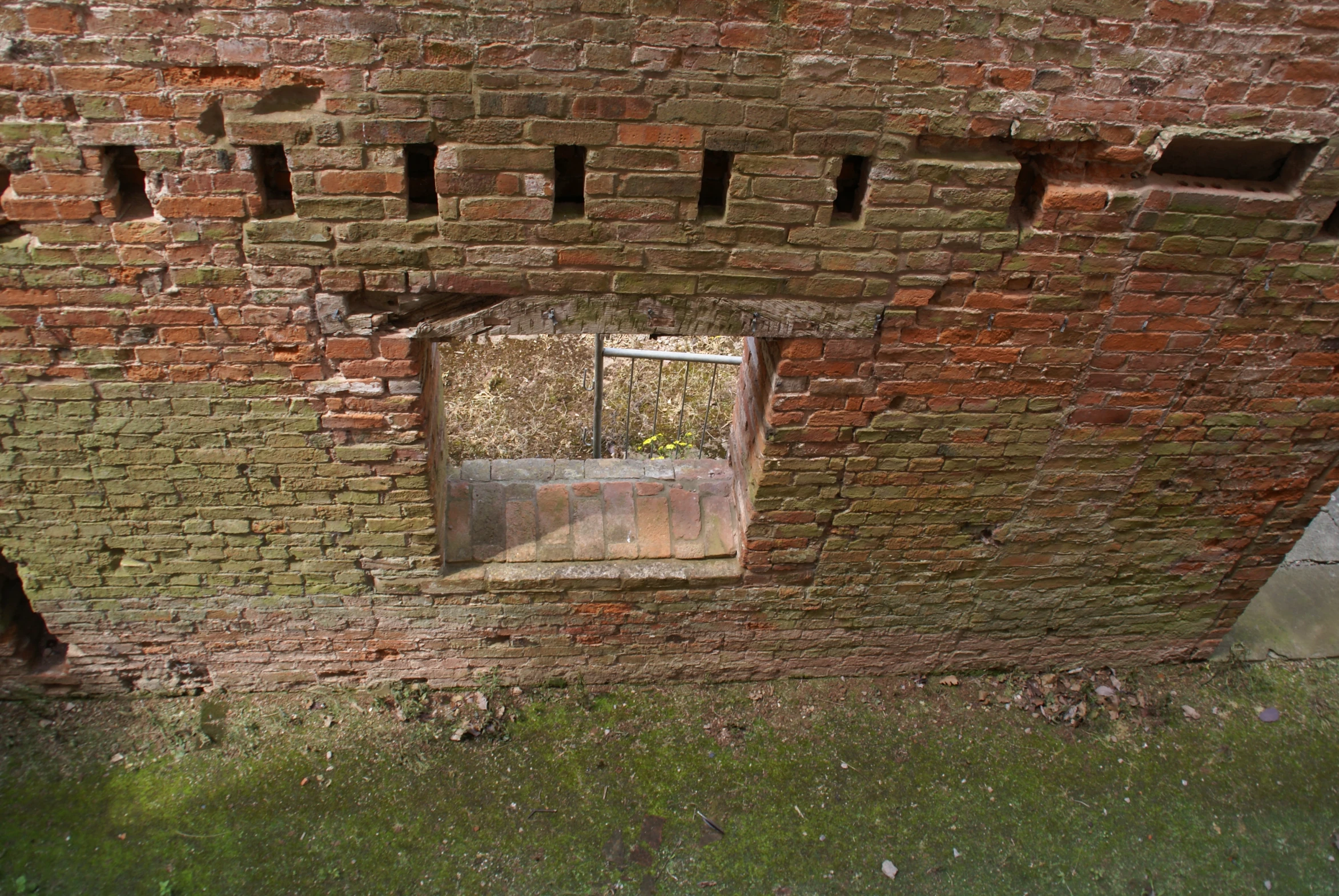 an empty window on a brick building made of bricks