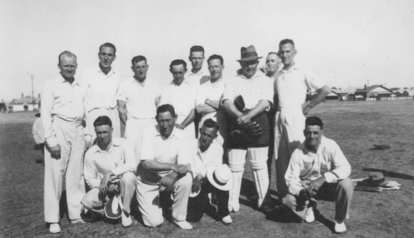 black and white po of nine men with hats and uniforms