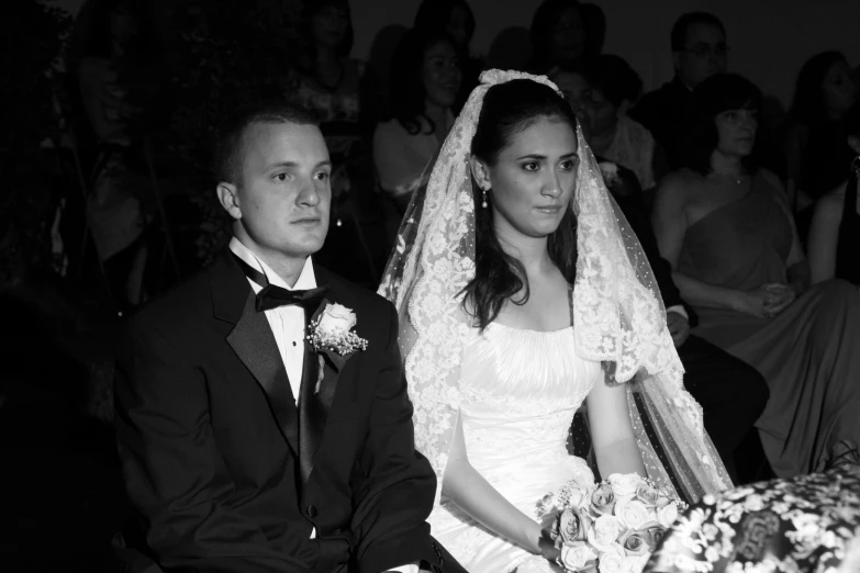 man and woman sitting side by side at their wedding