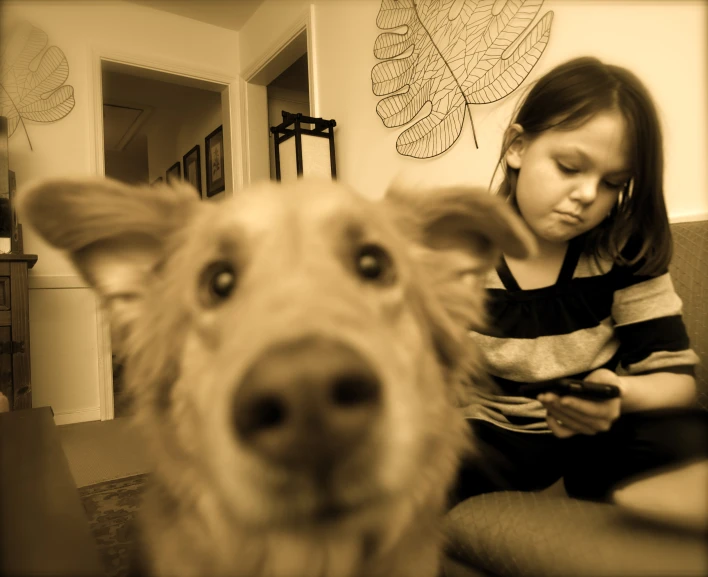 the girl and the dog have their faces together
