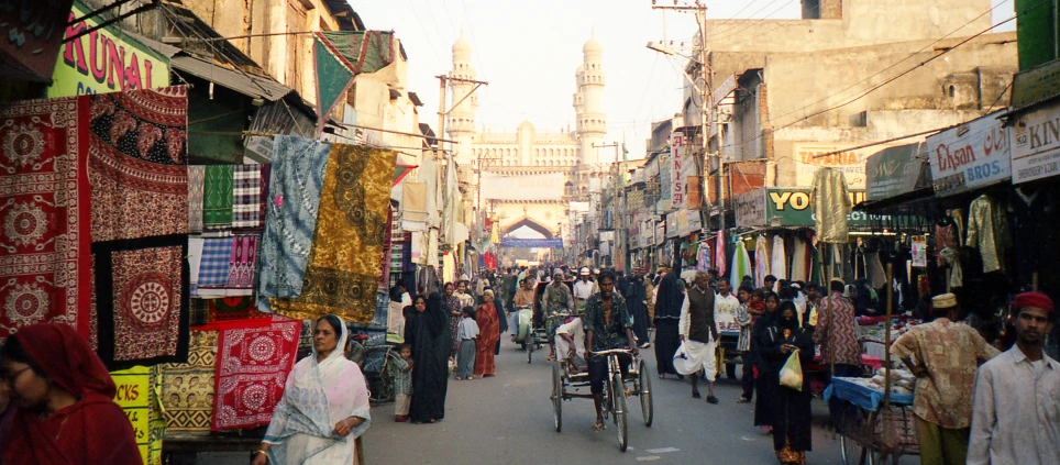 a busy street with shops and people shopping