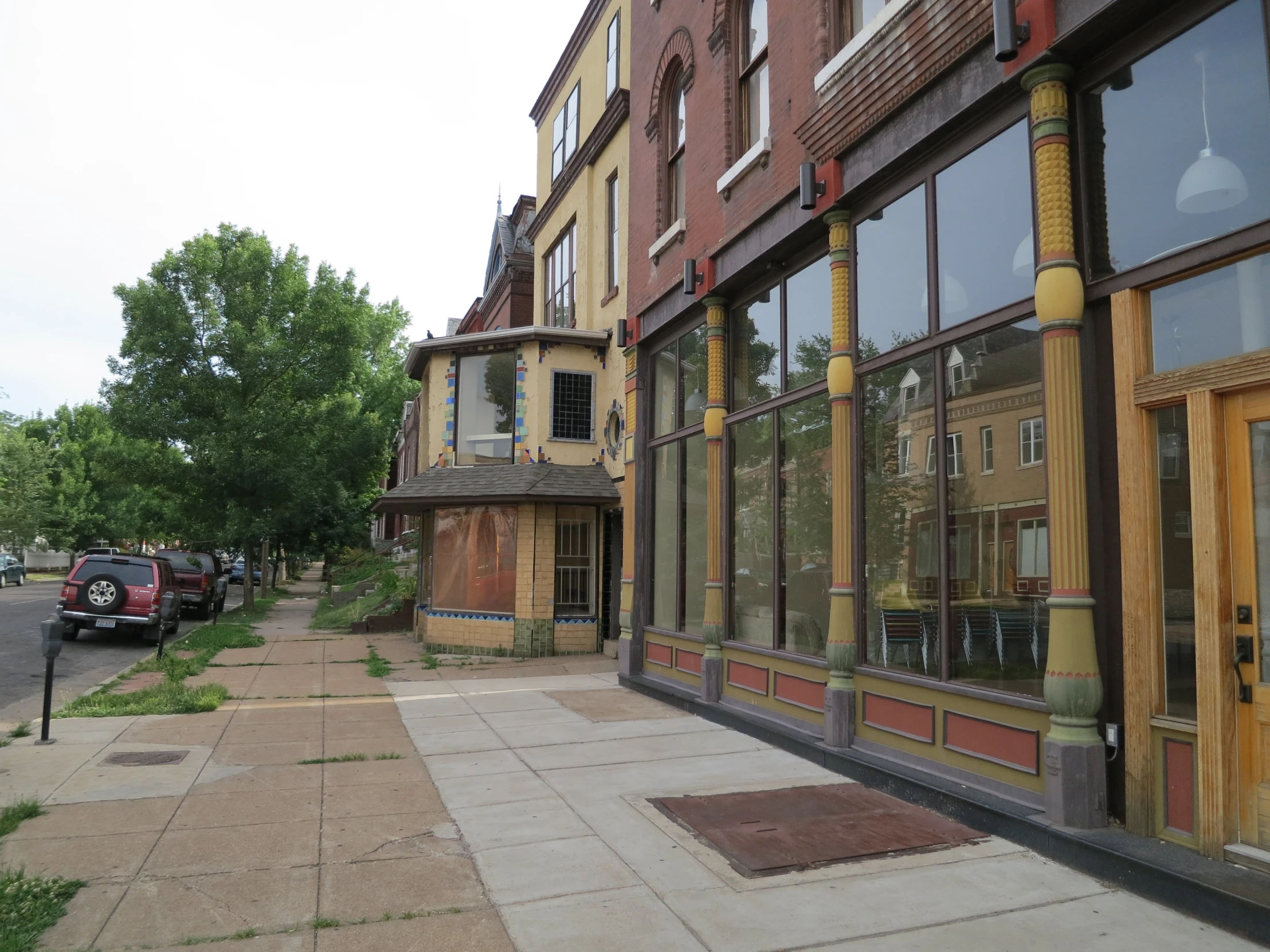 a large brick building with many windows is next to an empty parking lot