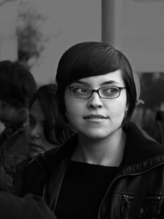 a young man wearing glasses on top of a subway train