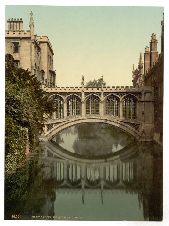 the old bridge is crossing over water near large buildings