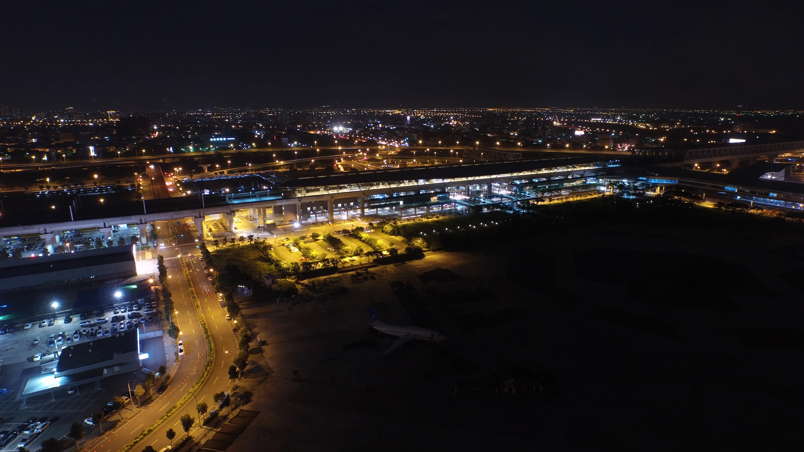 a large airport at night looking down from a high rise