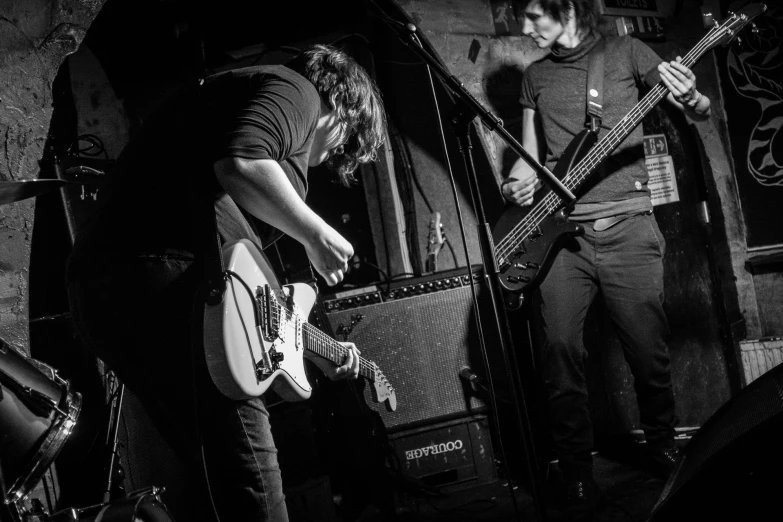 two people on guitars and some bassets