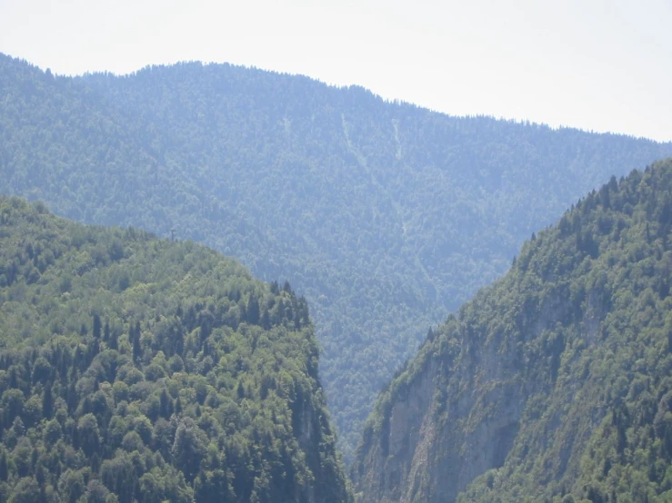 mountain scenery in the distance with people walking along a path