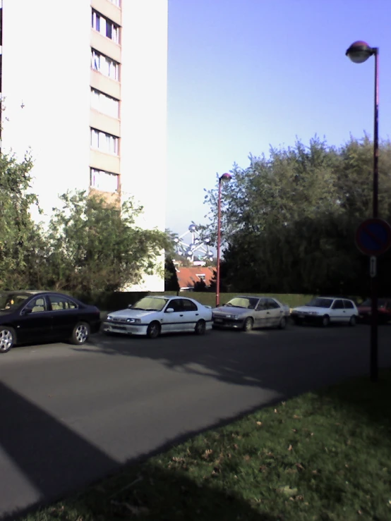 several cars parked in a parking lot near a street light