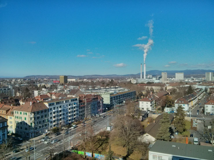 a po of a city with a factory smokestack in the distance