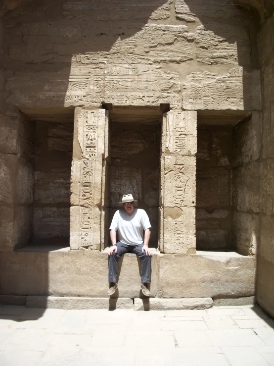 a man is sitting on steps outside of a structure