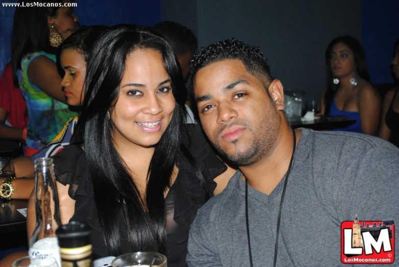 a couple at a bar posing for the camera