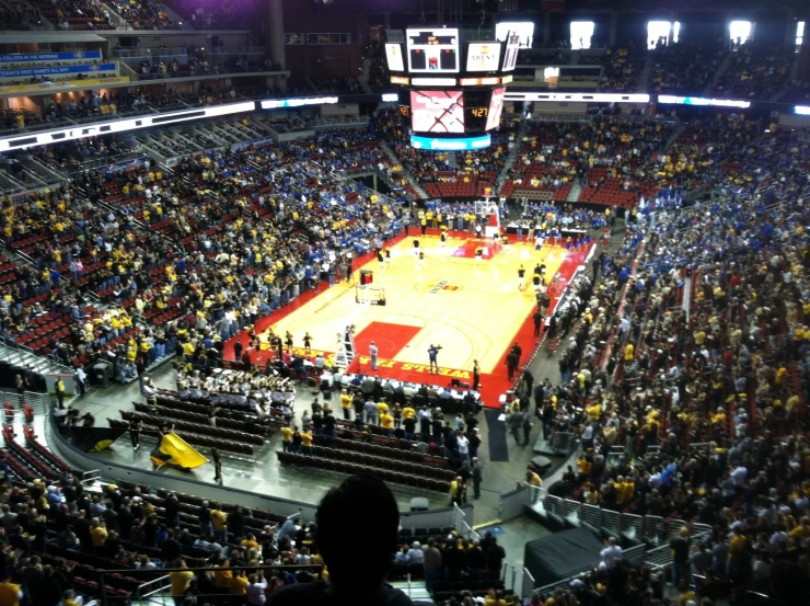 a huge basketball court surrounded by fans