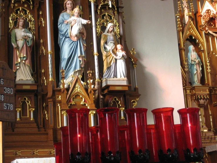 statues, candles and vases stand beside the alter