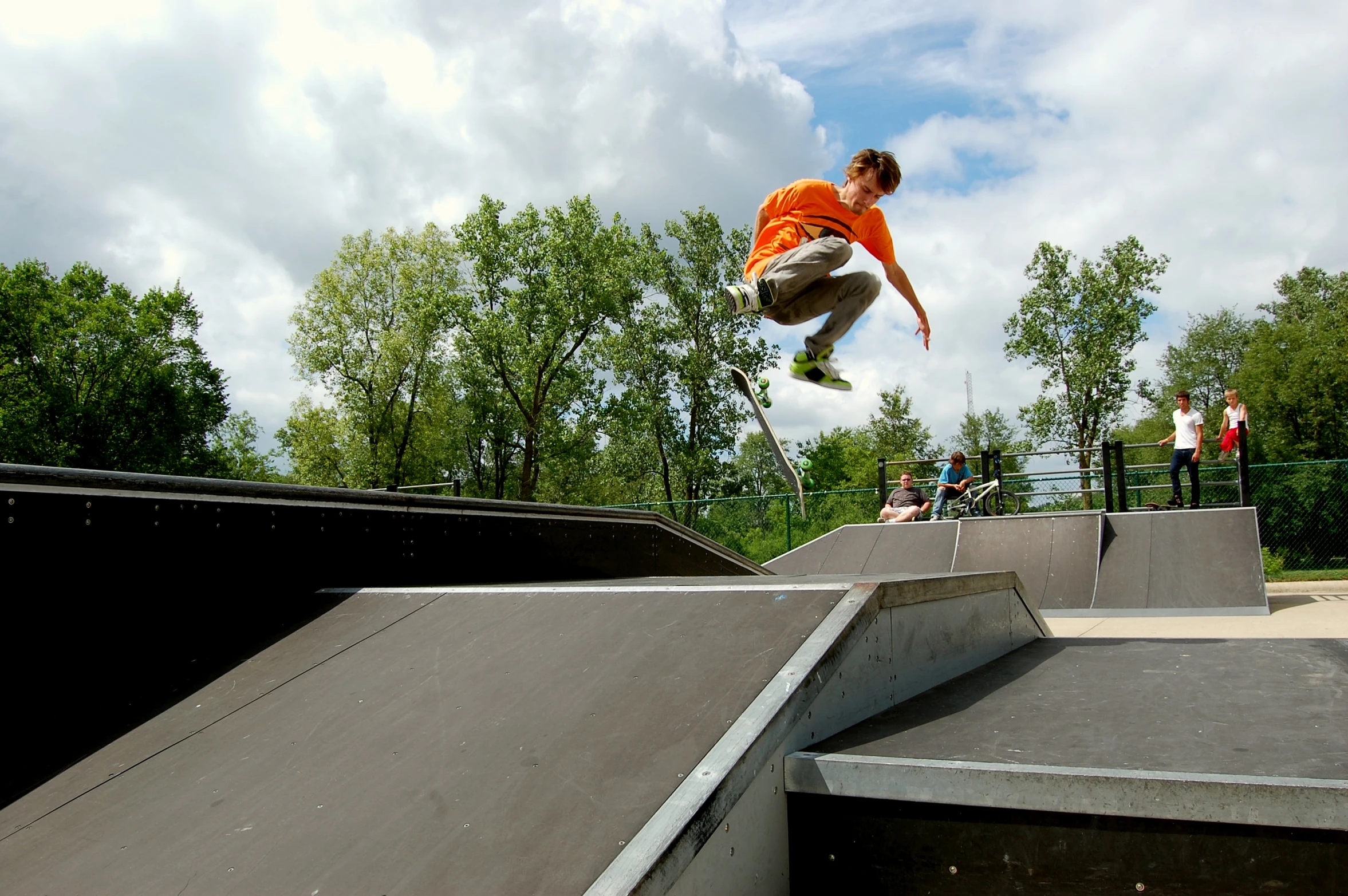 a young man riding his skateboard in an outdoor park