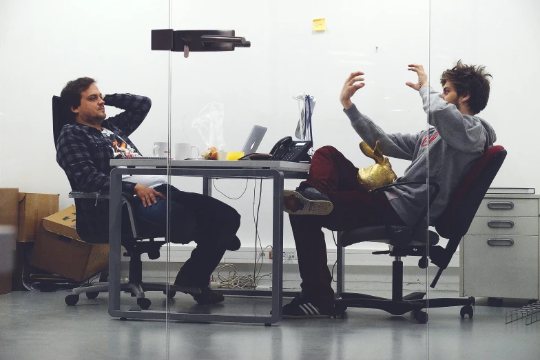 two people are having a discussion with each other at a table