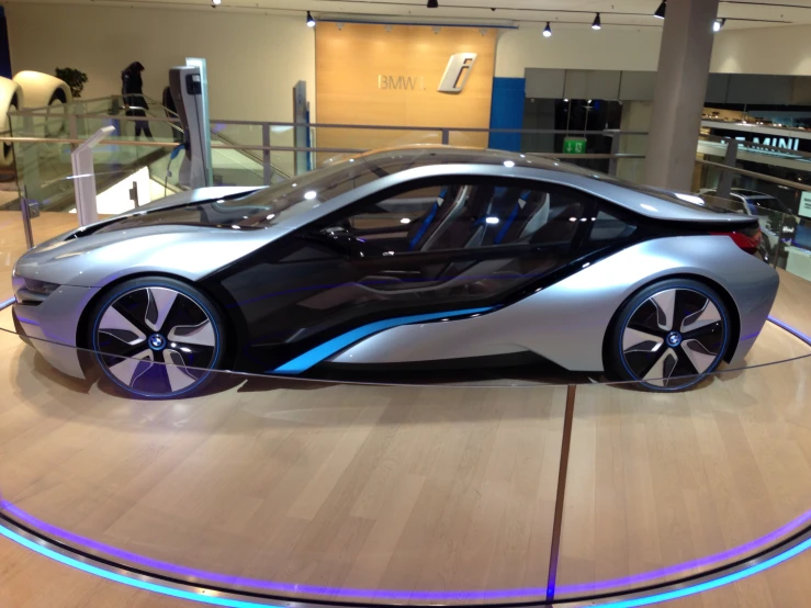 a modern looking car displayed in a showroom