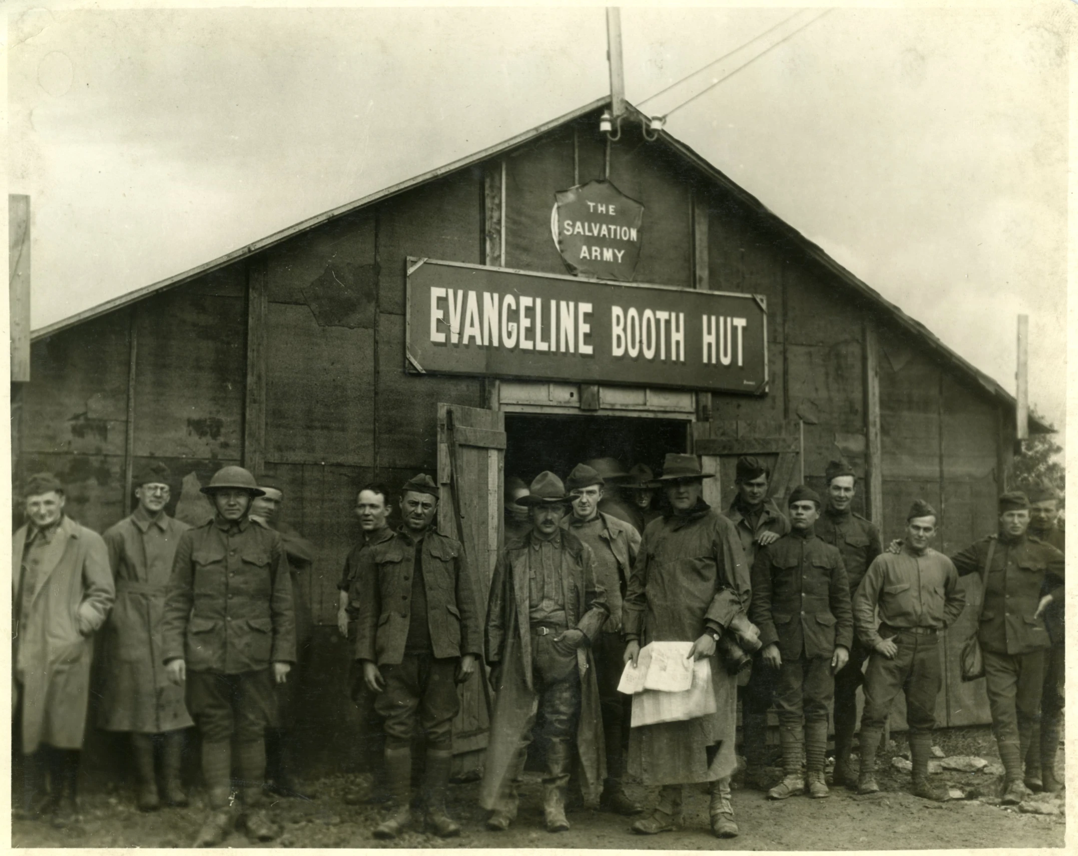 a group of people standing in front of a wooden building