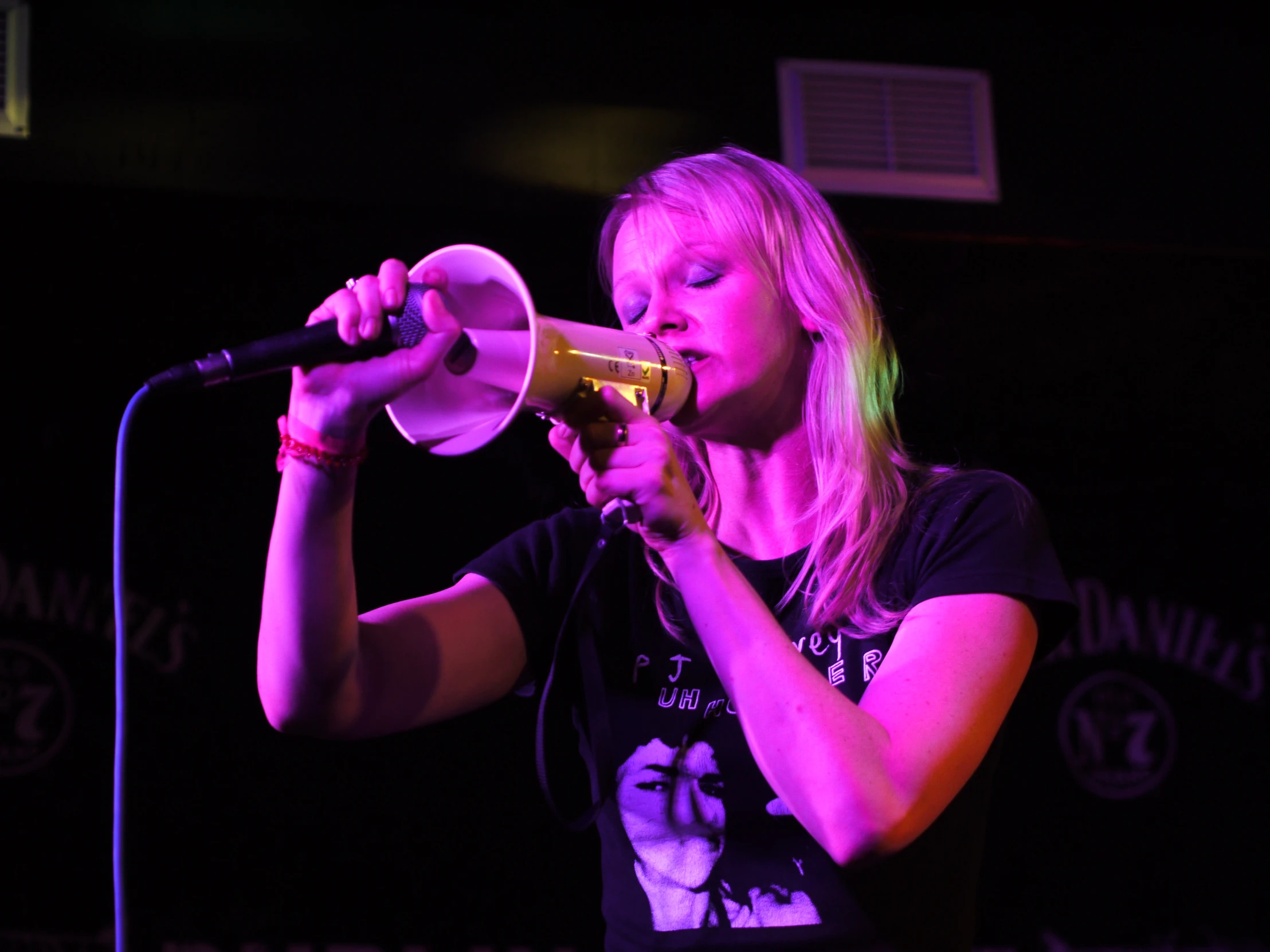 a woman that is standing in front of a microphone