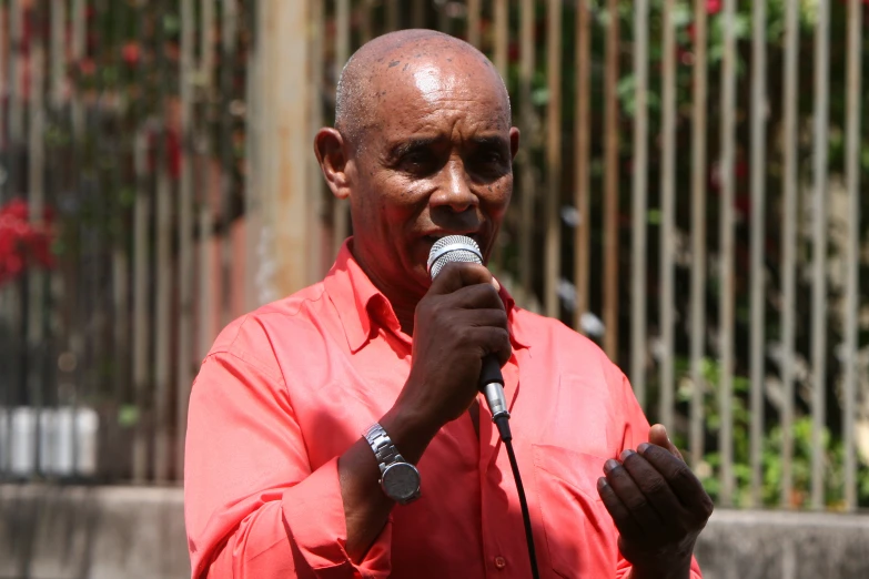 an african american man is standing with a microphone