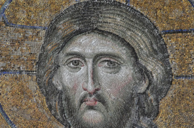 a mosaic portrait of jesus is displayed on the ground