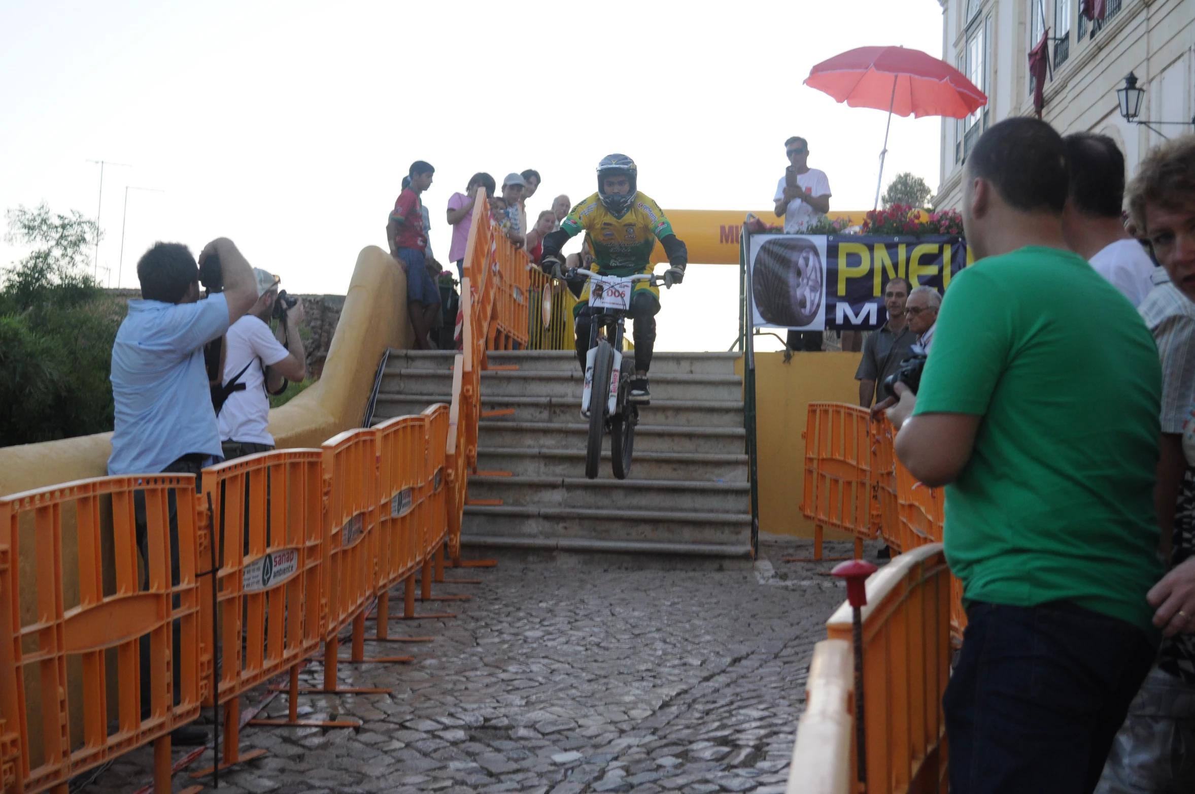 a group of people watching bicycles ride down a set of stairs