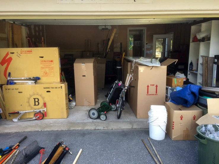 a garage with boxes, a hchain, and a carton