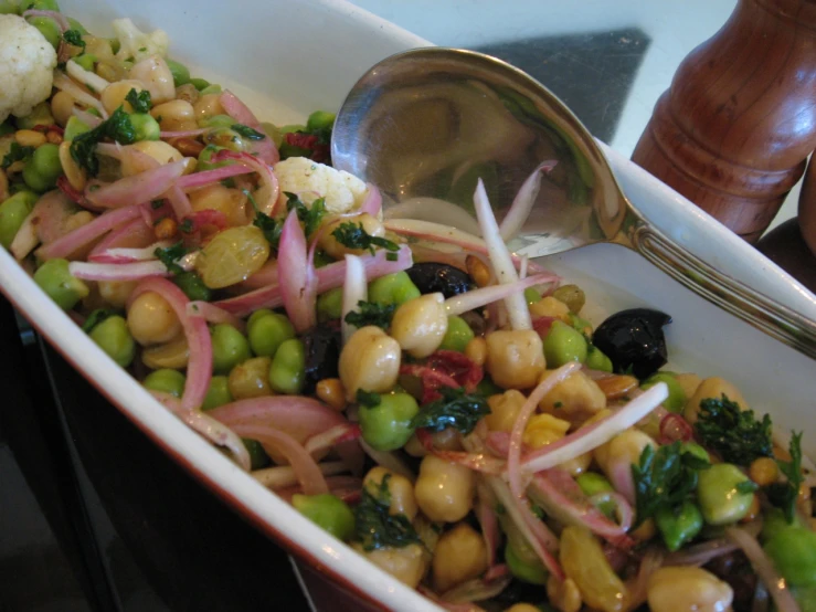 a bowl of mixed vegetables with a spoon