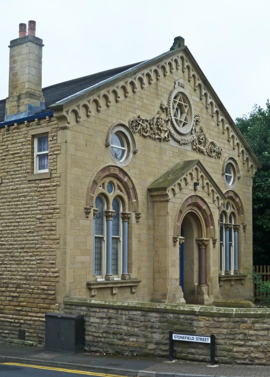 a building made out of rock has stonework around the outside