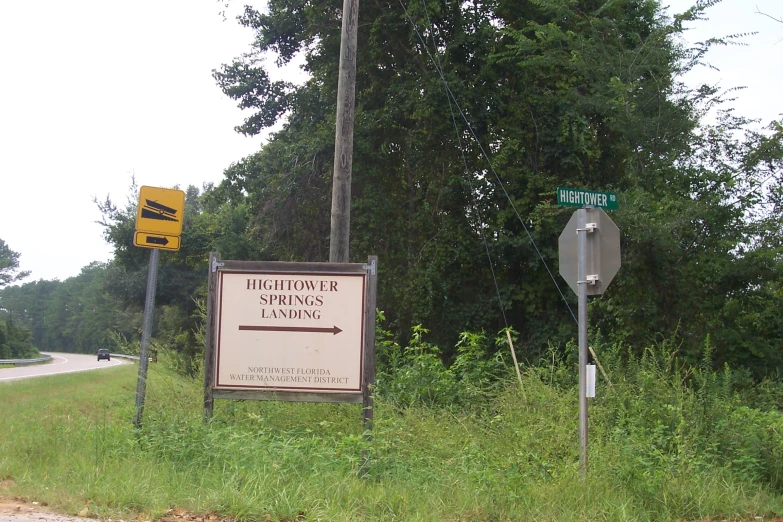 there are two parking signs and a signpost on the side of the road