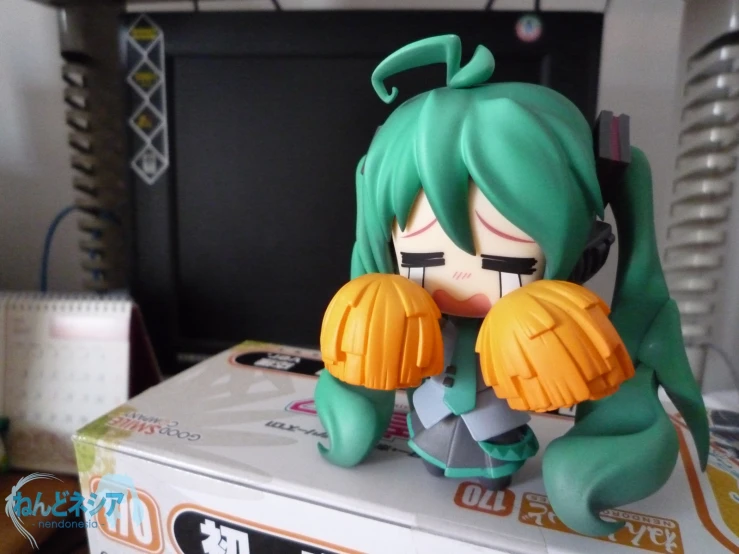 a figure of a female character sits on a box