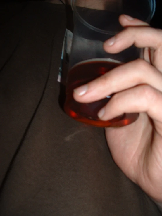 a person holding onto an object with a glass