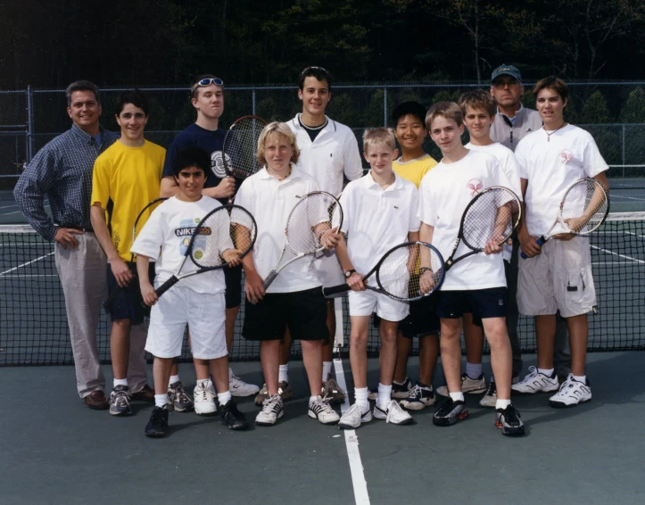 a group of tennis players pose together for a po