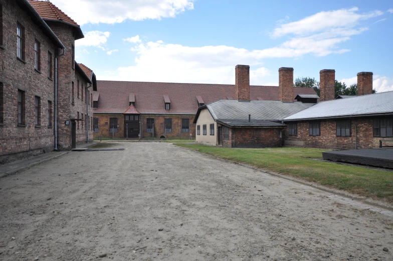 the empty parking lot and brick buildings of an abandoned village