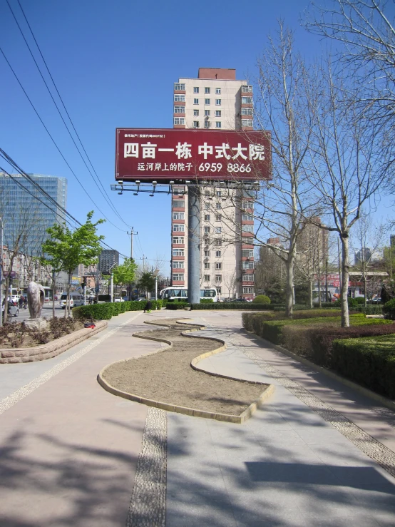 an empty parking lot next to a sign with chinese writing