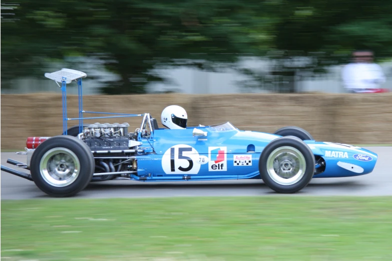 an old style race car on a road