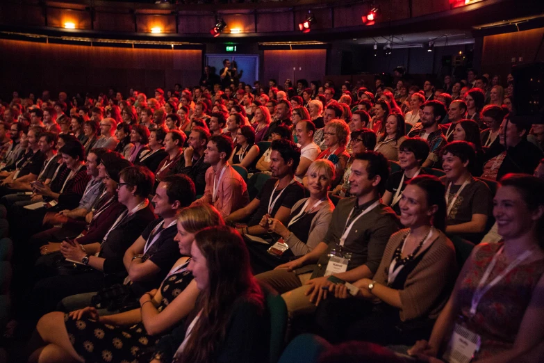 a very large group of people in a dark auditorium