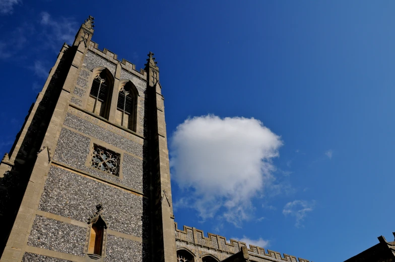 an old tower with two clocks against a blue sky